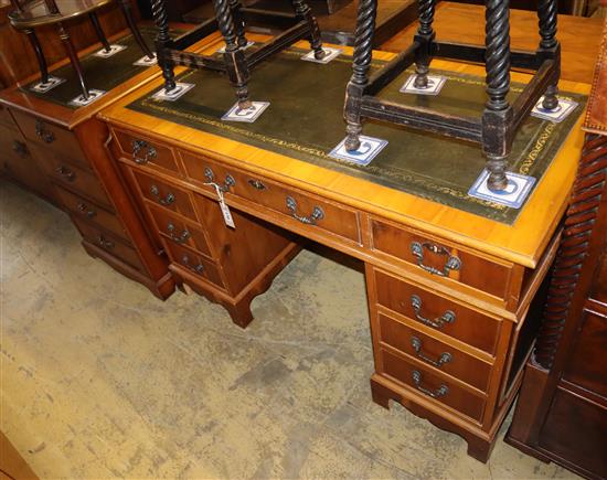 A reproduction yew pedestal desk, W.120cm, D.59cm, H.76cm together with a similar two drawer filing cabinet